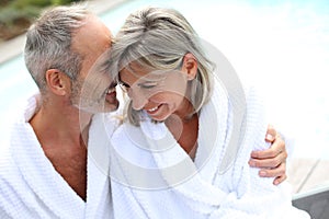 Couple in bathrobe standing together