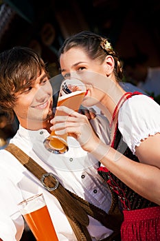 Couple in Bavarian Tracht drinking wheat beer