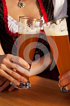 Couple in Bavarian Tracht drinking wheat beer photo