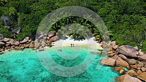 Couple on the beach of Anse Lazio Praslin island Seychelles,Secret bay small beach of Anse Petite