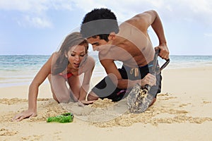 Couple on the beach digging
