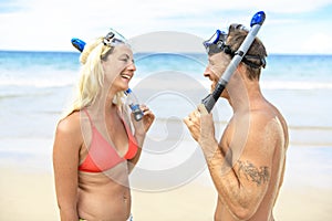 Couple on the beach is going to swim and snorkle on hawaii beach