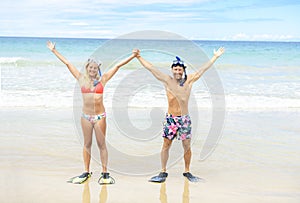 Couple on the beach is going to swim and snorkle on hawaii beach