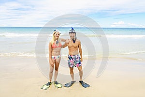 Couple on the beach is going to swim and snorkle on hawaii beach