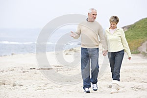 Couple at the beach holding hands and smiling