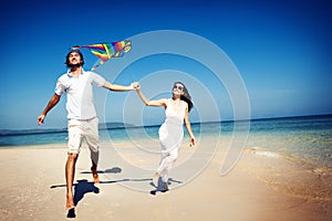 Couple Beach Kite Flying Getaway Holiday Concept