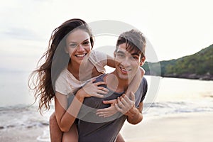Couple, beach and piggyback with sea, smile and nature with travel and date for relationship. Man, woman and indonesia