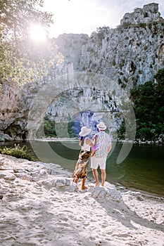 Couple on the beach by the river in the Ardeche France Pont d Arc, Ardeche France,view of Narural arch in Vallon Pont D