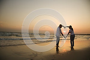 Couple on beach at sunset.