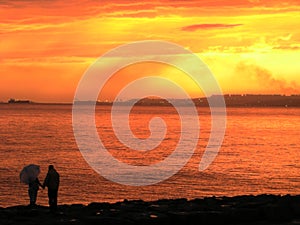 Silhouetted couple on beach