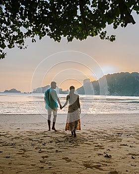 Couple on the beach during sunset at the tropical Krabi area Thailand, Ao Nam Mao beach Krabi Ao Nang area Thailand,men