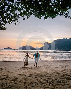 Couple on the beach during sunset at the tropical Krabi area Thailand, Ao Nam Mao beach Krabi Ao Nang area Thailand,men