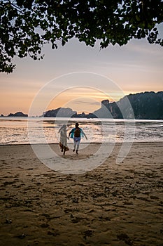 Couple on the beach during sunset at the tropical Krabi area Thailand, Ao Nam Mao beach Krabi Ao Nang area Thailand,men