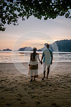 Couple on the beach during sunset at the tropical Krabi area Thailand, Ao Nam Mao beach Krabi Ao Nang area Thailand,men