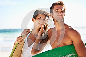 Couple, beach and surf, holiday and travel with summer and bonding outdoor, sport and people on a date. Ocean, wind and