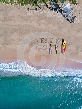 Couple on the beach with Test Go sign on the beach in Thailand Pattaya, Test and Go sign on theb beach from above with