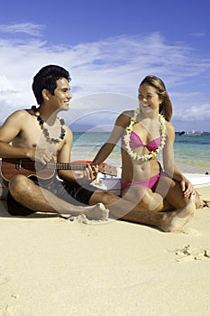Couple on beach with ukulele
