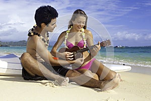 Couple on beach with ukulele
