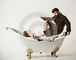 Couple of bearded man and sensual woman in bathroom. Couple enjoy morning routing. Family couple relax in bath. Couple