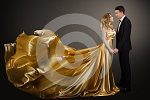 Couple, Beautiful Woman in Golden Silk Dress and Elegant Man, Fluttering Gown photo