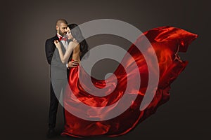 Couple Beauty Portrait, Beautiful Woman Dancing in Red Dress and Elegant Man, Fluttering Gown