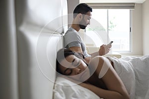 Couple In Bed With Cheating Man Texting On Smartphone