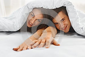 Couple in bed under the blanket