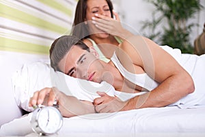 Couple in bed waking up