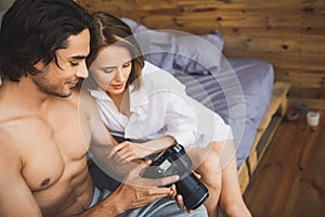 Couple on a bed watching pictures