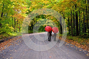 Couple beneath Red Umbrellas