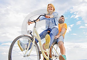 Couple with bicycle romantic date sky background. Couple in love date cycling. Explore city. Man and woman rent bike to