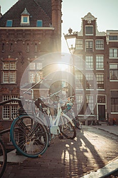 Couple of bicycles parked in a row in front of a backdrop of traditional buildings in Amsterdam