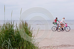 Couple on a bike ride along the beach