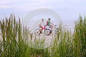 Couple on a bike ride along the beach