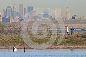 Couple birding with Manhattan skyline background