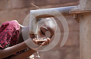 Couple of Black African Children Drinking Water from tap, Human Rights, Poverty, Climate Change