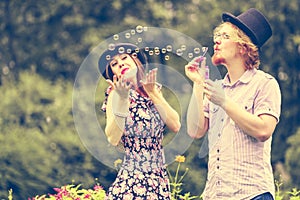 Couple blowing bubbles outdoor