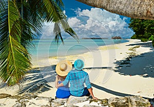 Couple in blue clothes on a beach at Maldives