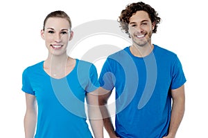 Couple in blue t-shirts. Isolated over white.