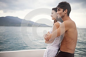 Couple, boat and embrace on ocean on vacation, love and relax by water on summer holiday. People, cruise and bonding for