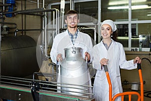 Couple bottling milk on manufacture