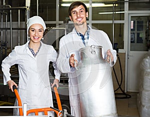 Couple bottling milk on manufacture