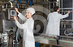 Couple bottling milk on manufacture