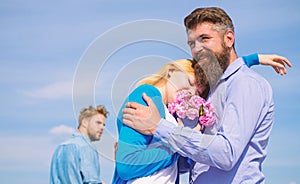 Couple with bouquet romantic date. Ex husband jealous on background. Couple in love dating outdoor sunny day, sky