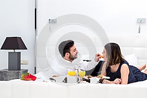 Couple at breakfast in hotel room.
