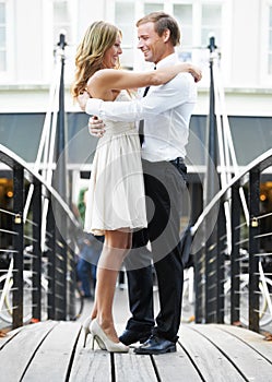 Couple, bridge and hug outdoor with love, care and romantic valentines date with happiness together. Man, woman and