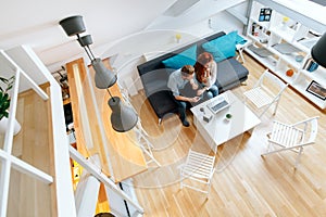 Couple browsing web together in living room