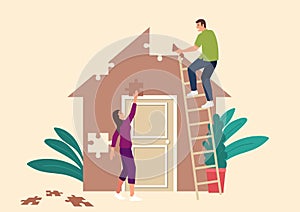 Couple building a house made from puzzle pieces