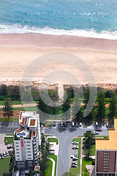 Couple of buildings in front of a beach