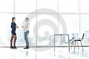 Couple of business man, woman talk about document Object tool in office room against blue sky window with houses